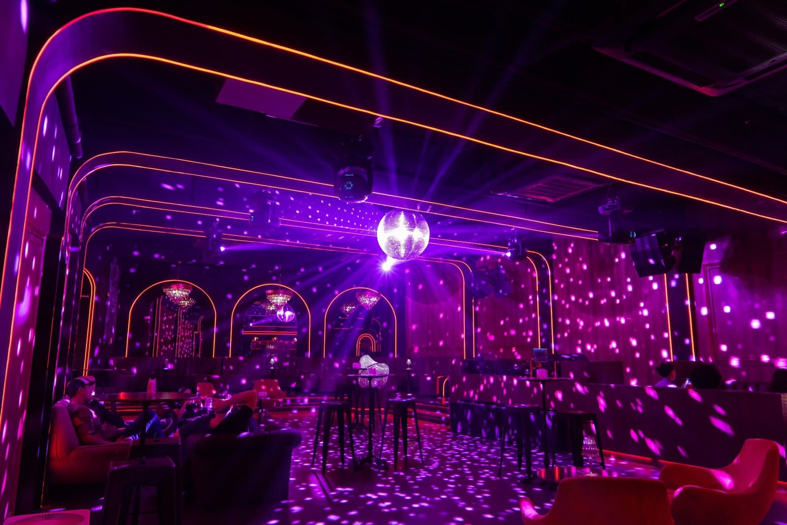 Wide view of the room, with the dance floor, bar, and mirrored wall.